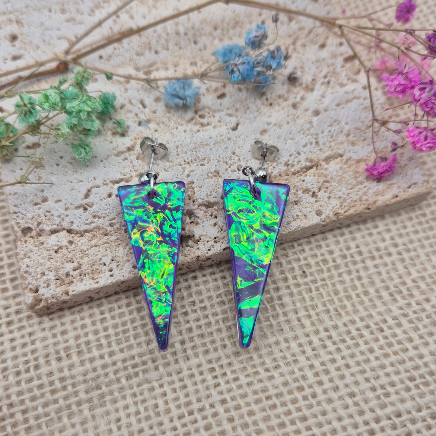 Triangle-shaped statement earrings reflecting colourful light, handmade in Wales