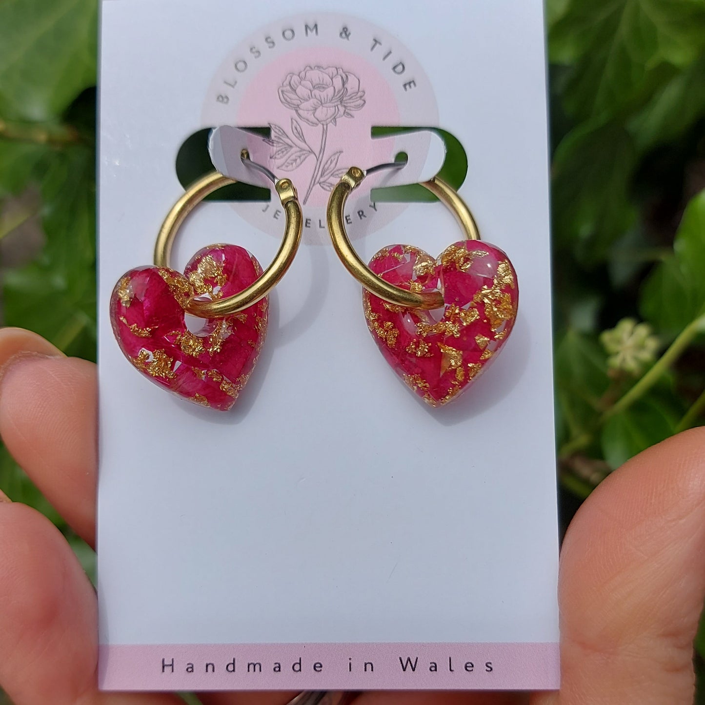 Heart-shaped hoop earrings filled with real rose petals and gold leaf.
