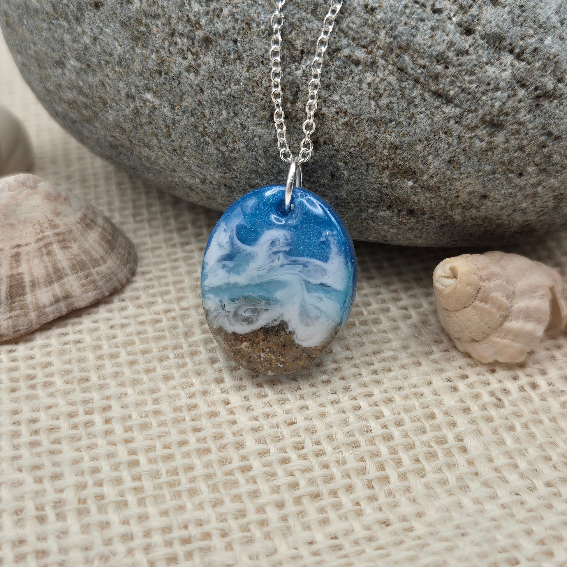 Handmade resin pendant featuring sand from West Wales beaches.