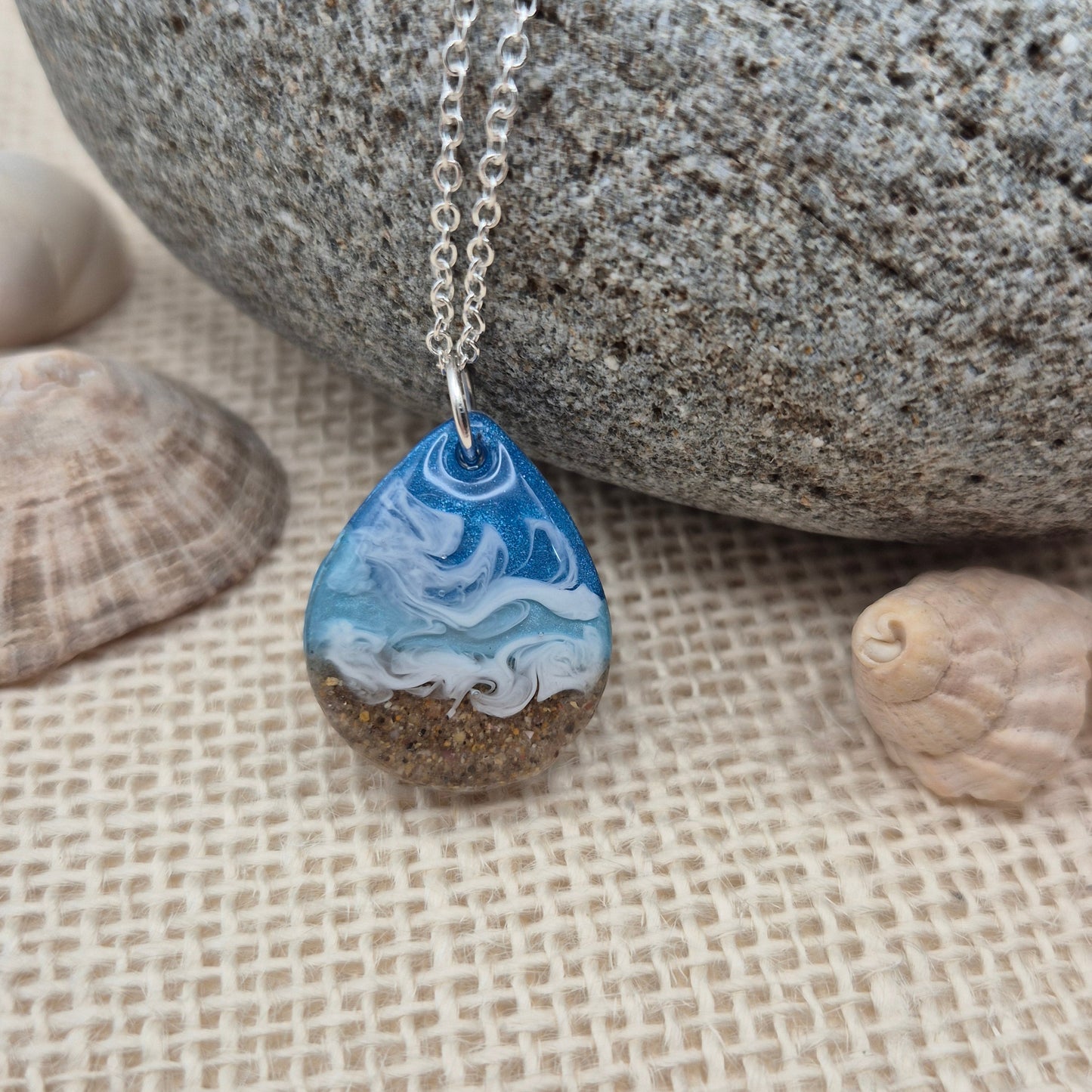 Handmade resin pendant featuring sand from West Wales beaches.