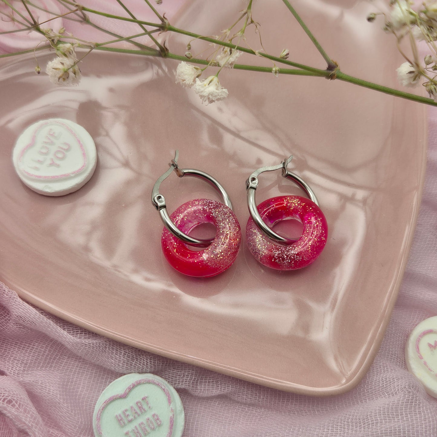 Romantic handcrafted donut hoop earrings presented on a branded card.