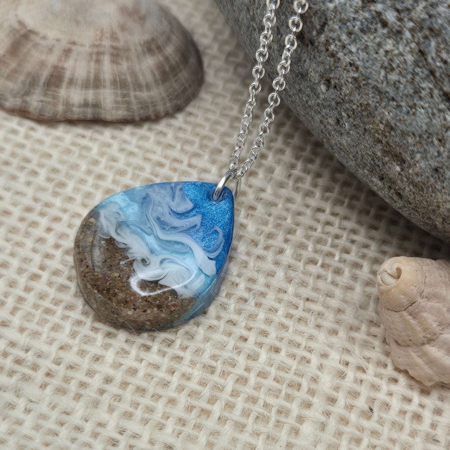 Handmade resin pendant featuring sand from West Wales beaches.