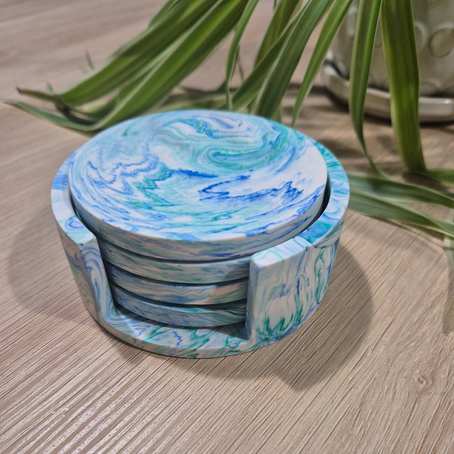 blue and green set of 4 handmade coasters. In matching holder.