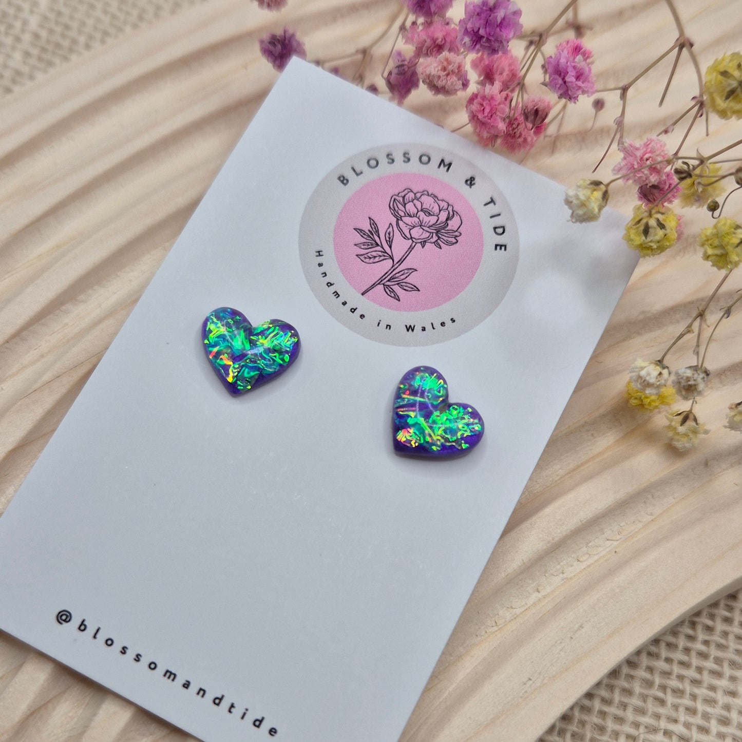 Heart-shaped stud earrings on branded display card, presented in an organza gift bag