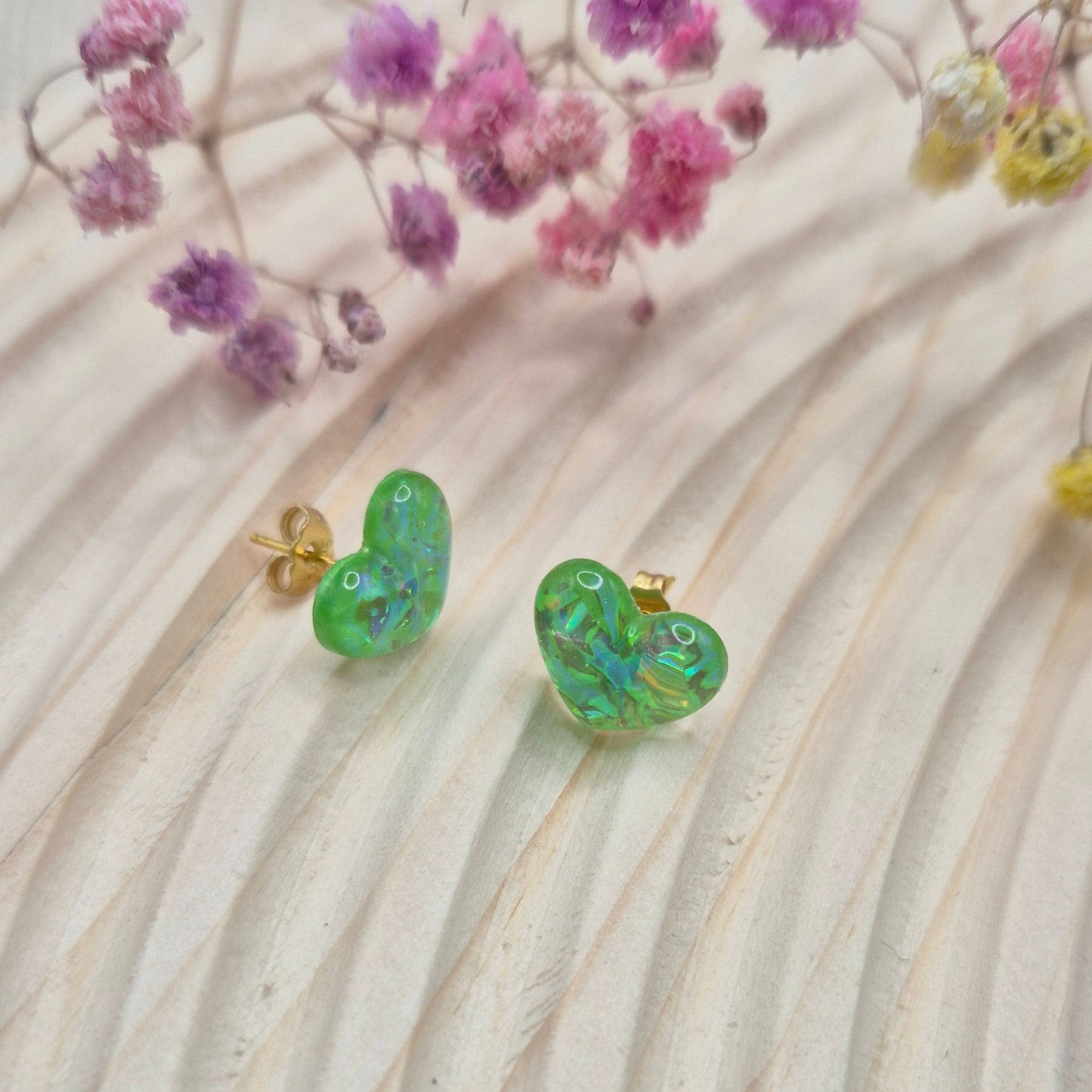 Holographic resin earrings catching the light, ideal for romantic or everyday wear