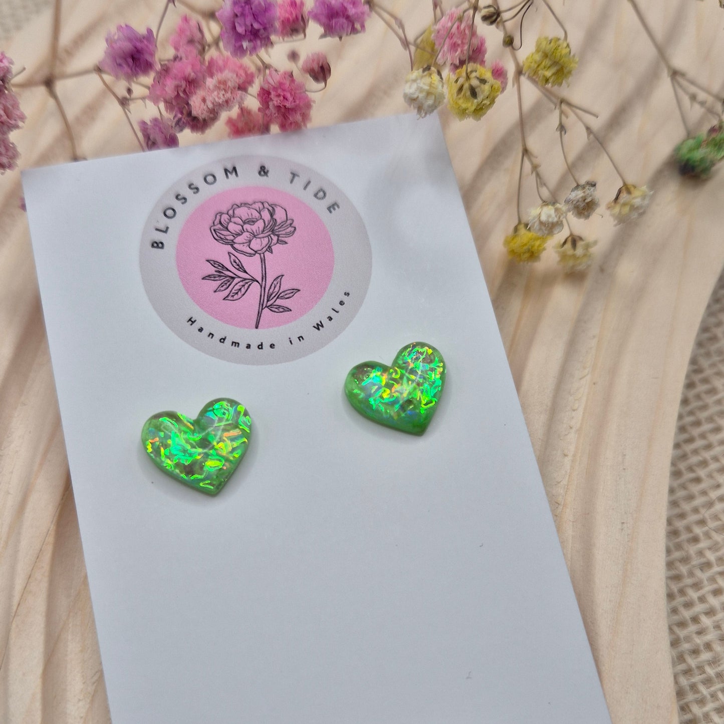 Holographic resin earrings catching the light, ideal for romantic or everyday wear