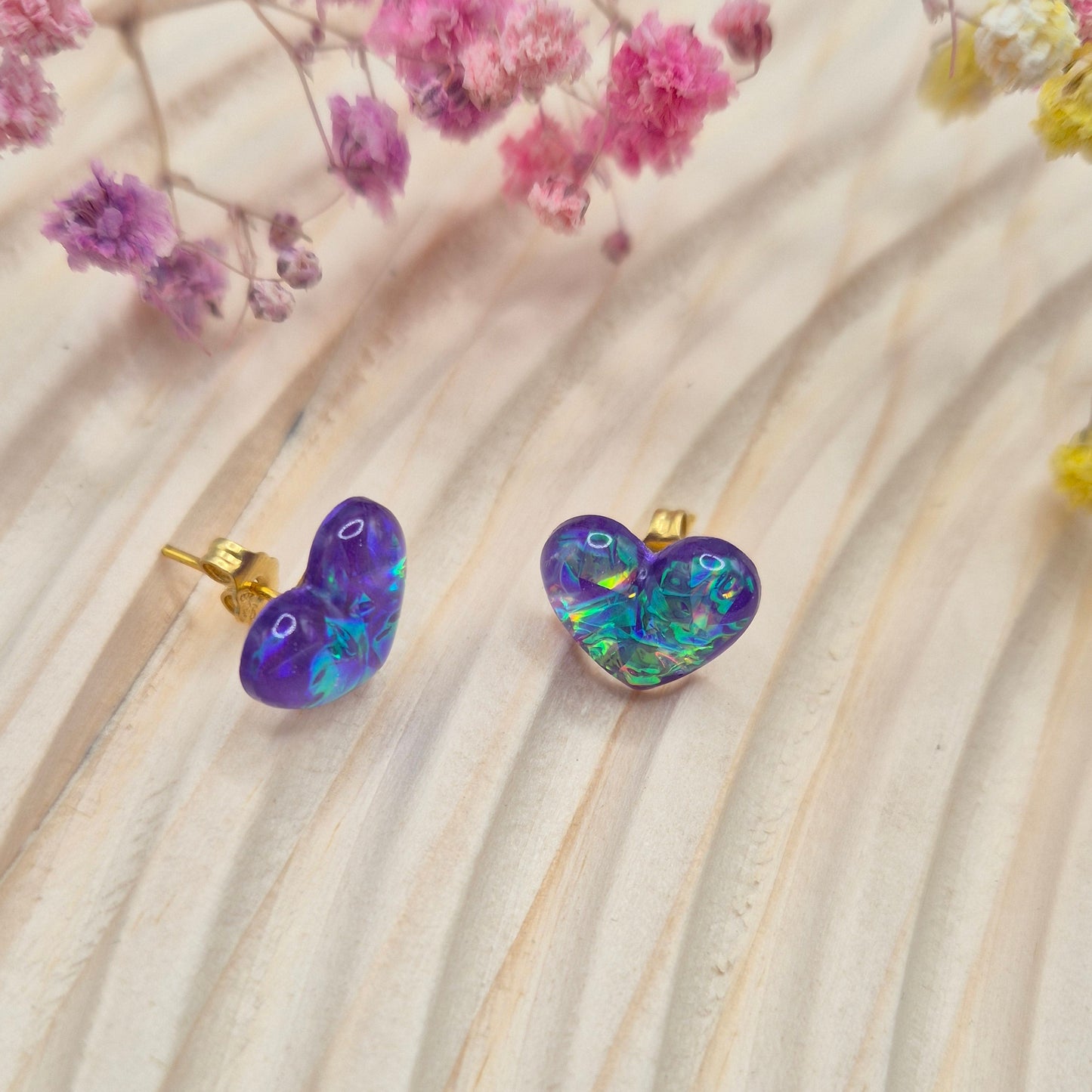 Heart-shaped stud earrings on branded display card, presented in an organza gift bag