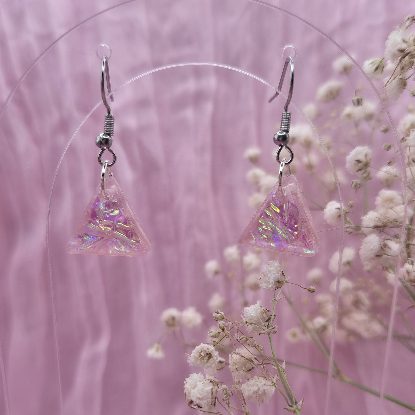 Triangle-shaped statement earrings reflecting colourful light, handmade in Wales