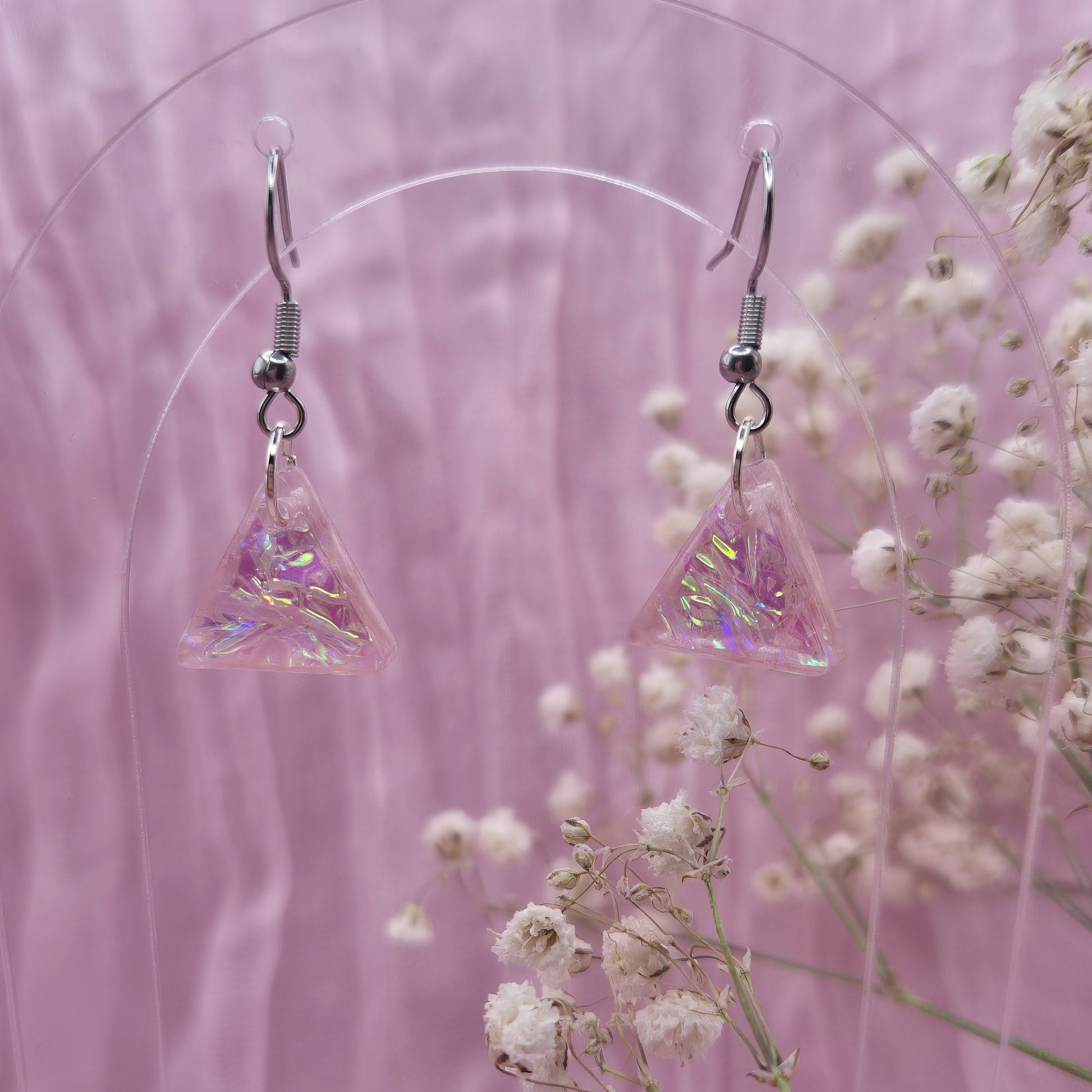 Triangle-shaped statement earrings reflecting colourful light, handmade in Wales