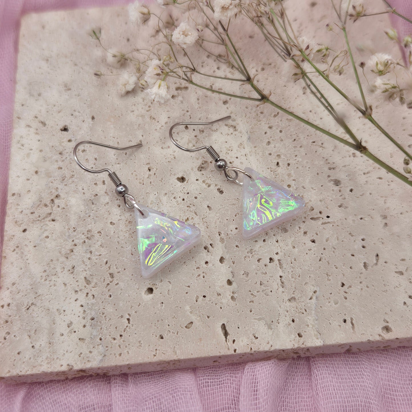 Triangle-shaped statement earrings reflecting colourful light, handmade in Wales