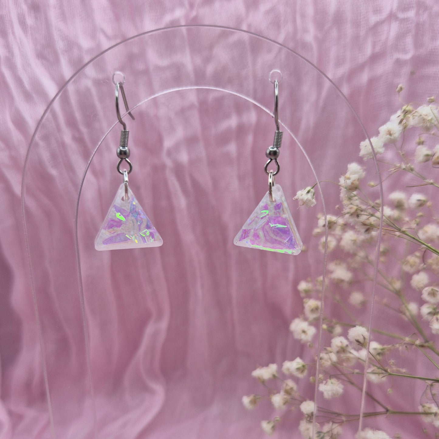 Triangle-shaped statement earrings reflecting colourful light, handmade in Wales