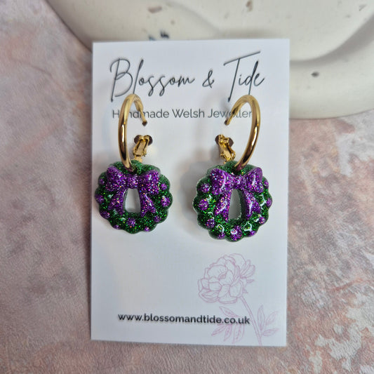 Pair of Christmas earrings on a display card with 'Blossom & Tide' branding.