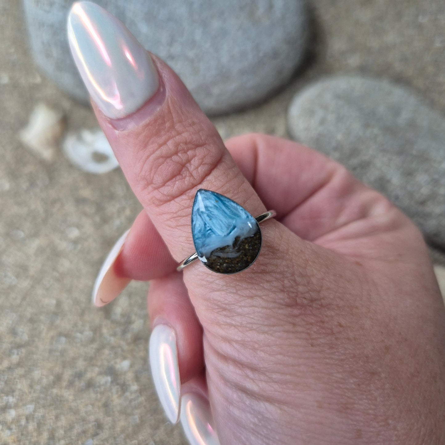 Teardrop shaped adjustable ring with Welsh beach sand.