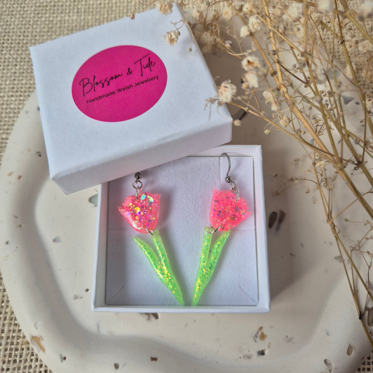 Peach pink glitter tulip dangle earrings with green stems on silver hooks. In Blossom & Tide box.