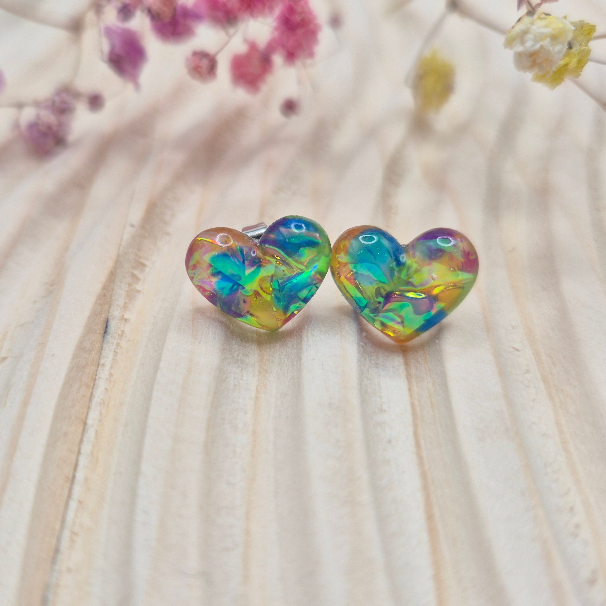 Holographic resin earrings catching the light, ideal for romantic or everyday wear