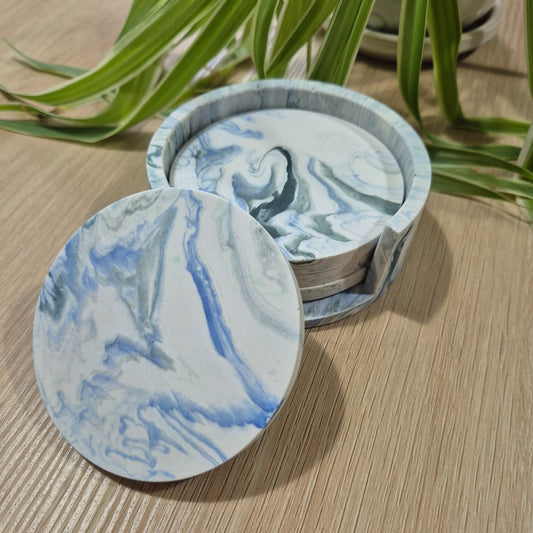 Set of four handmade Jesmonite marbled coasters with matching holder, eco-friendly and sealed with cork bases, made in West Wales.
