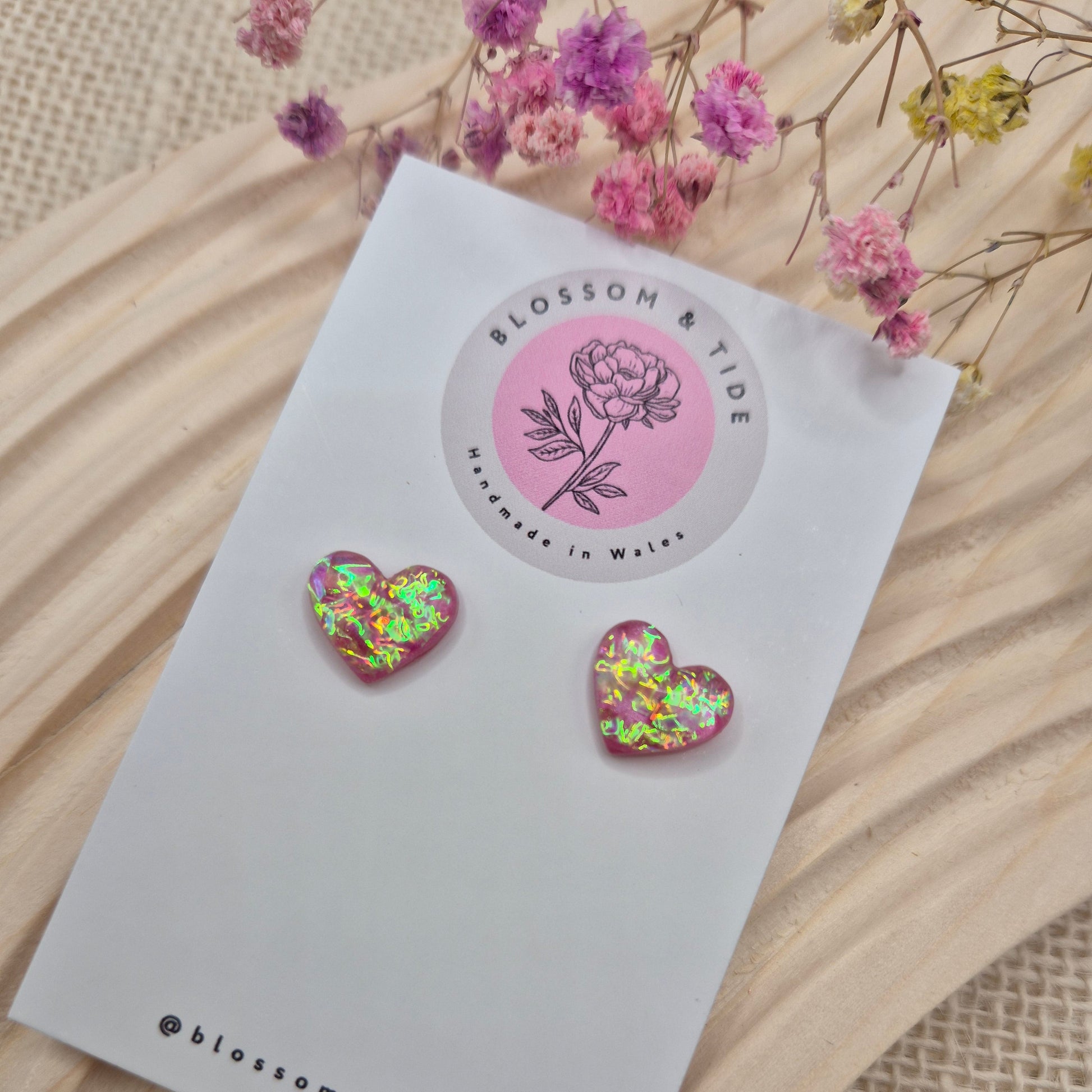 Heart-shaped stud earrings on branded display card, presented in an organza gift bag