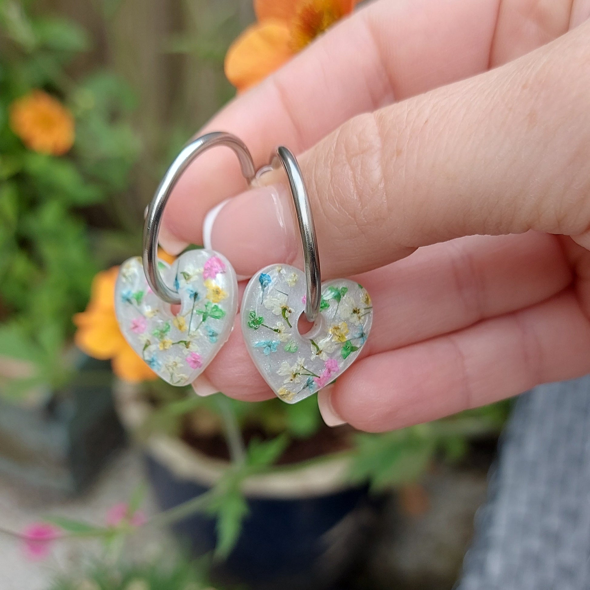 Whimsical multicoloured floral earrings with heart design.