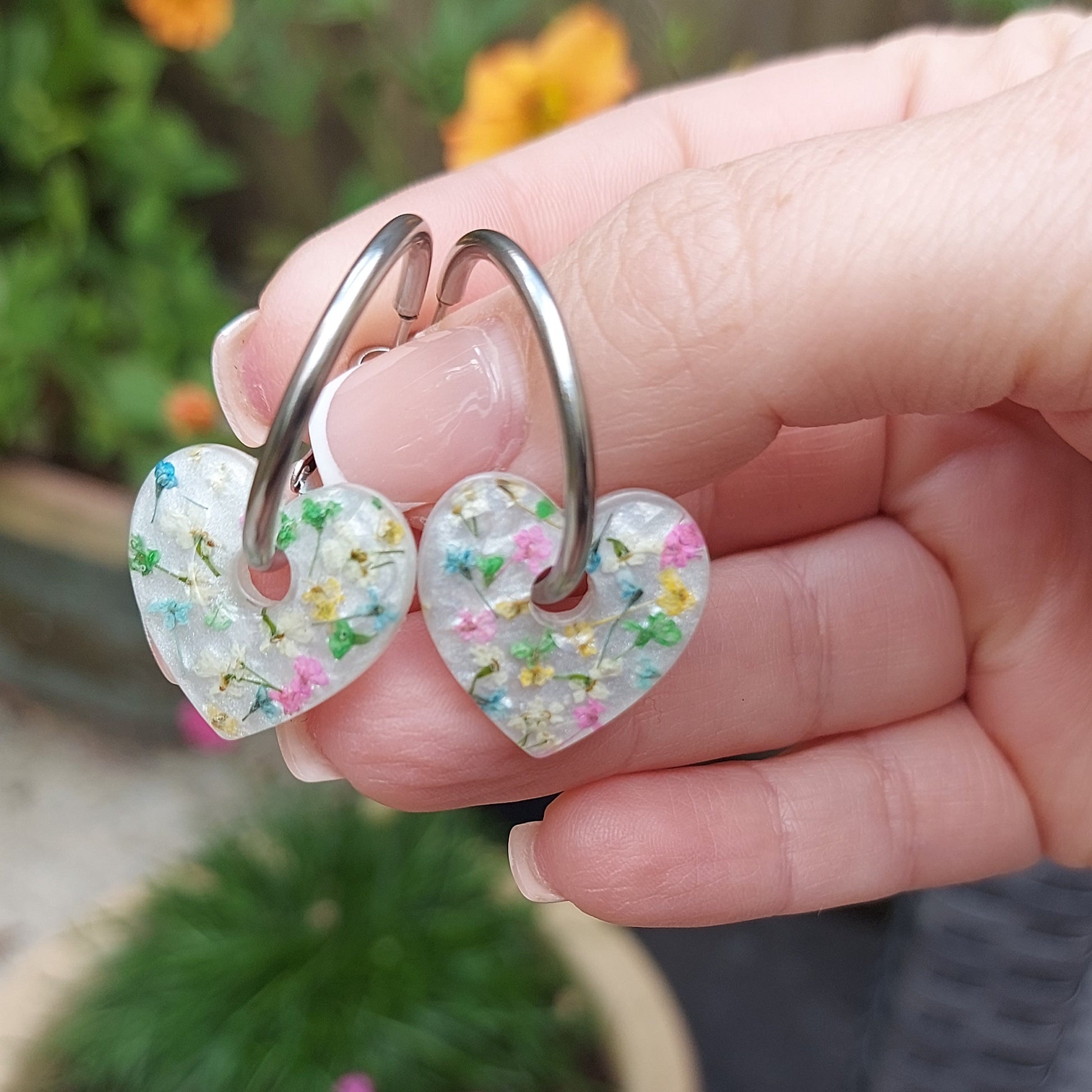 Whimsical multicoloured floral earrings with heart design.