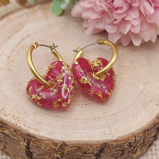 Heart-shaped hoop earrings filled with real rose petals and gold leaf.
