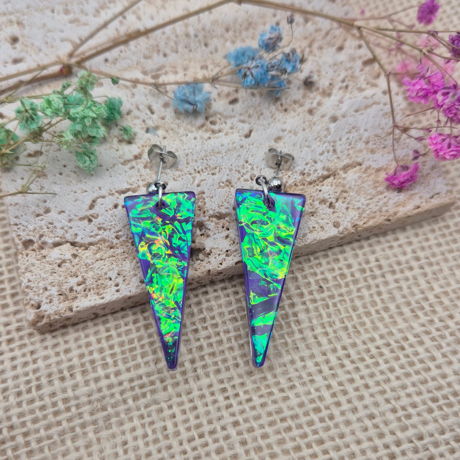 Triangle-shaped statement earrings reflecting colourful light, handmade in Wales
