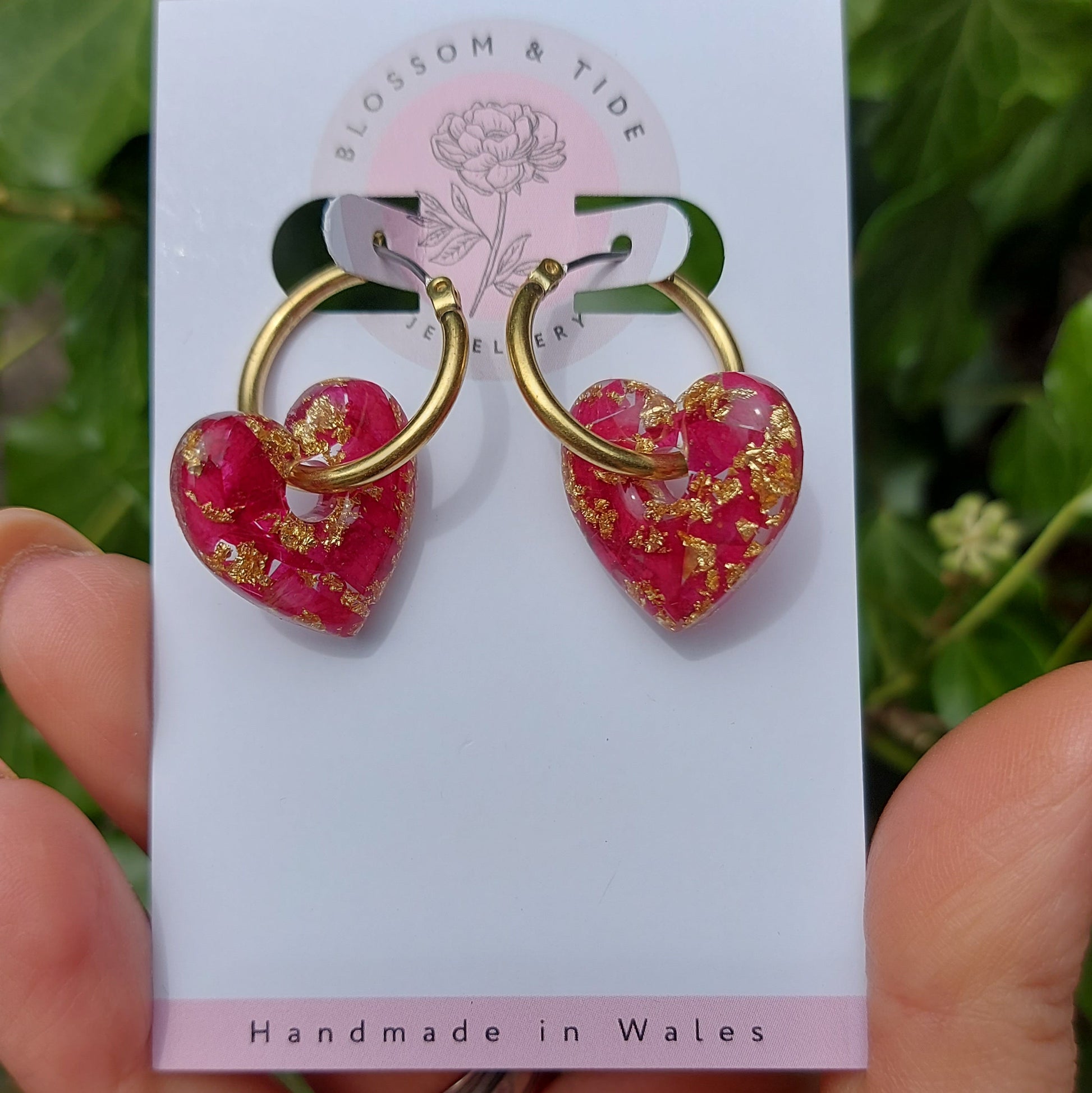 Heart-shaped hoop earrings filled with real rose petals and gold leaf.