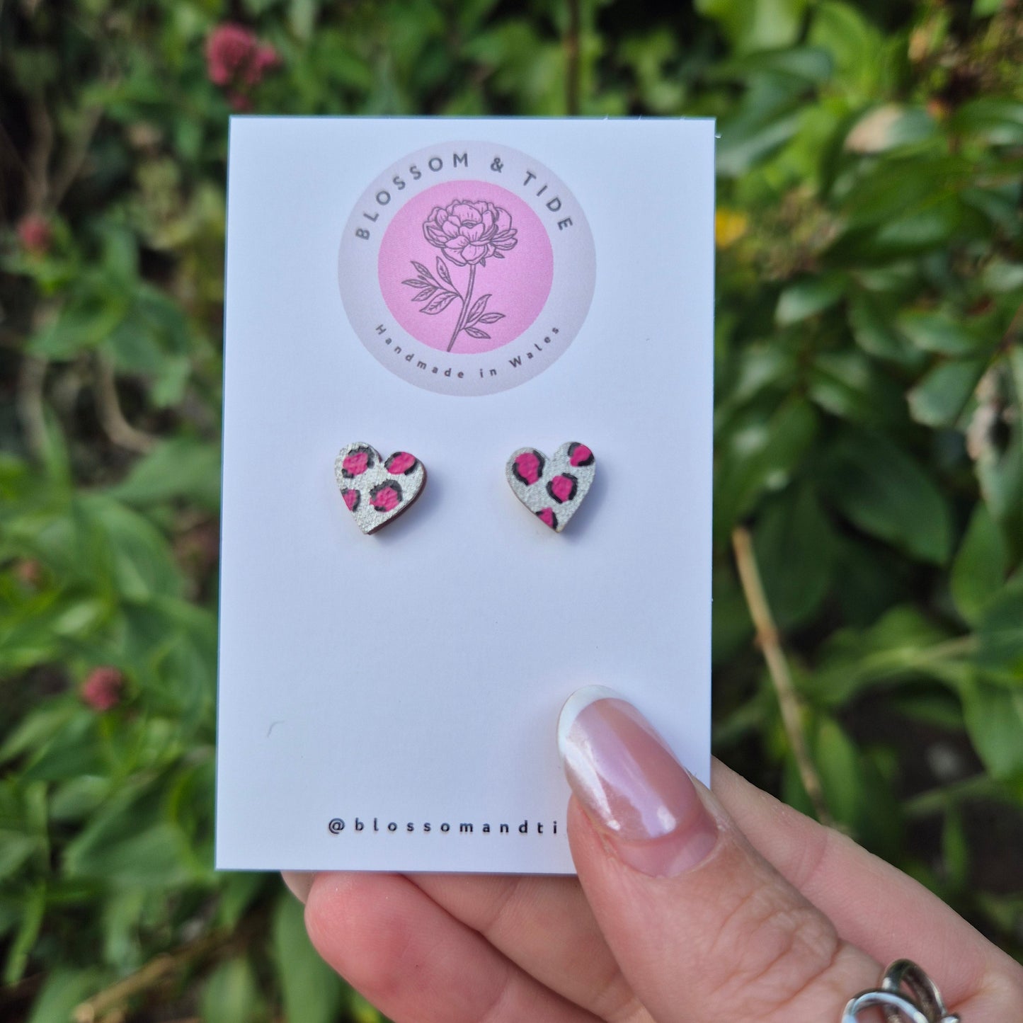 Hand painted metallic animal print heart shaped stud earrings on blossom and tide branded earring card 