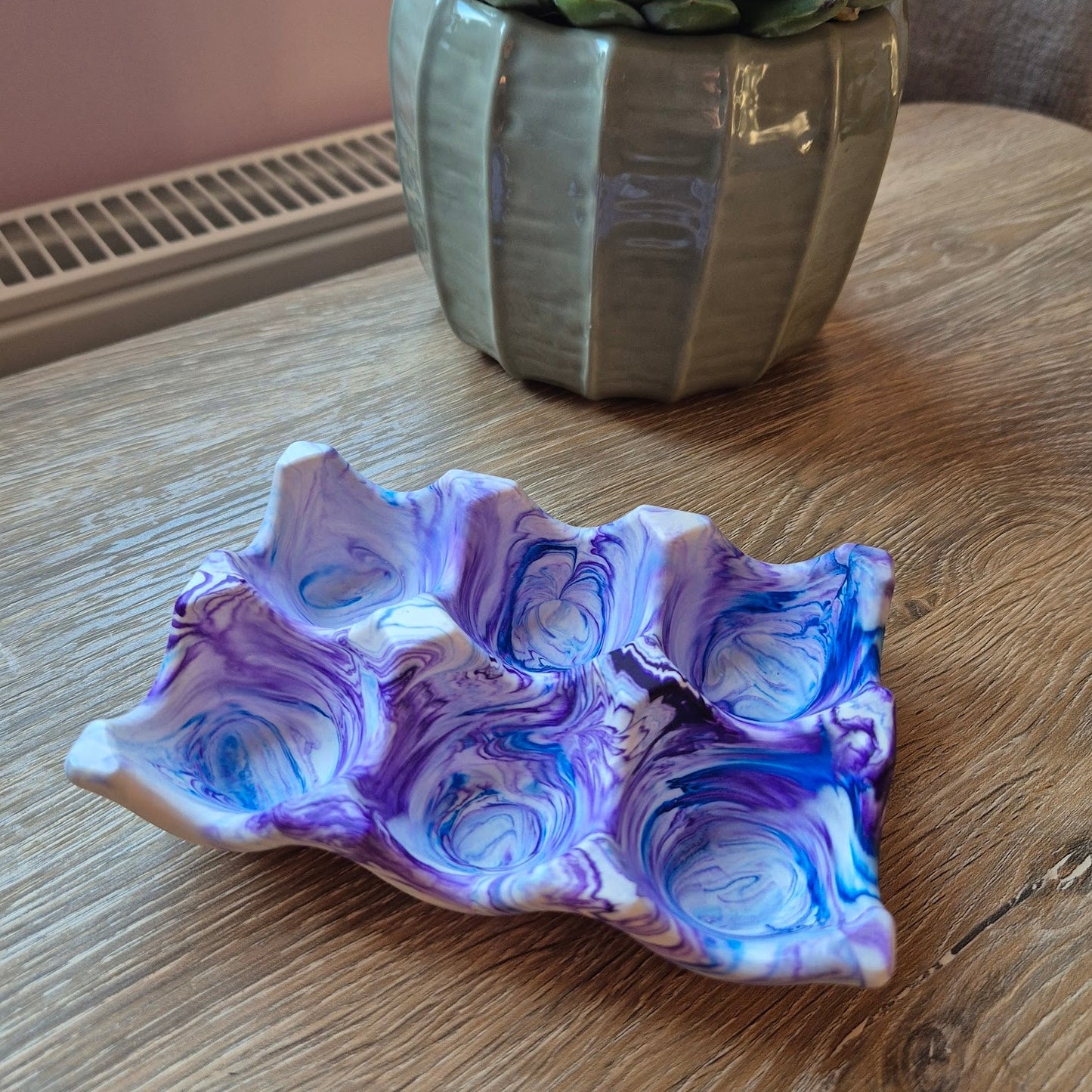 Jesmonite purple and blue marbled egg holder tray, on a wooden table