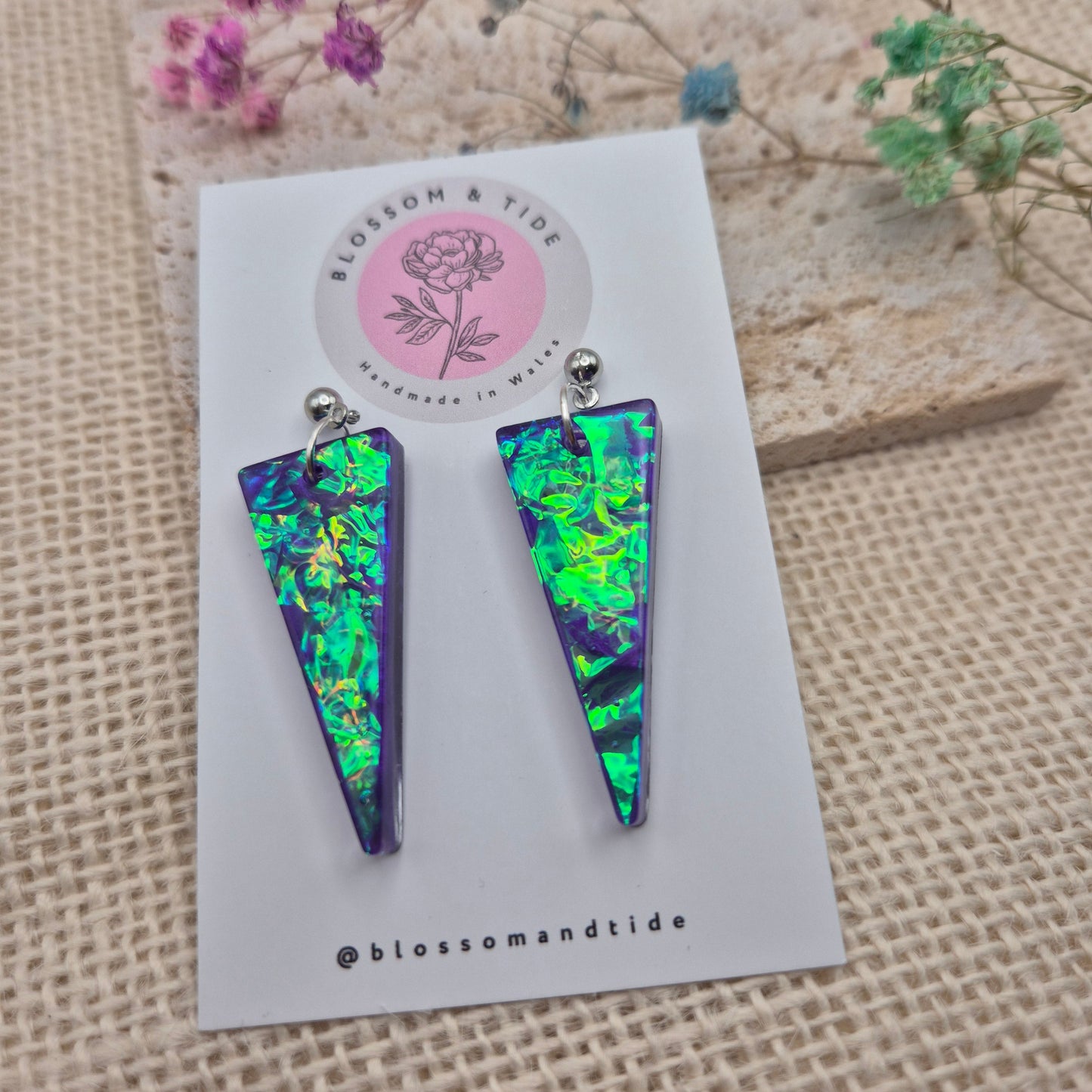 Long resin earrings presented on a branded display card with organza gift packaging