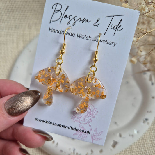 Mushroom earrings with orange flowers on stainless steel gold hooks Shown on Blossom & Tide branded card.