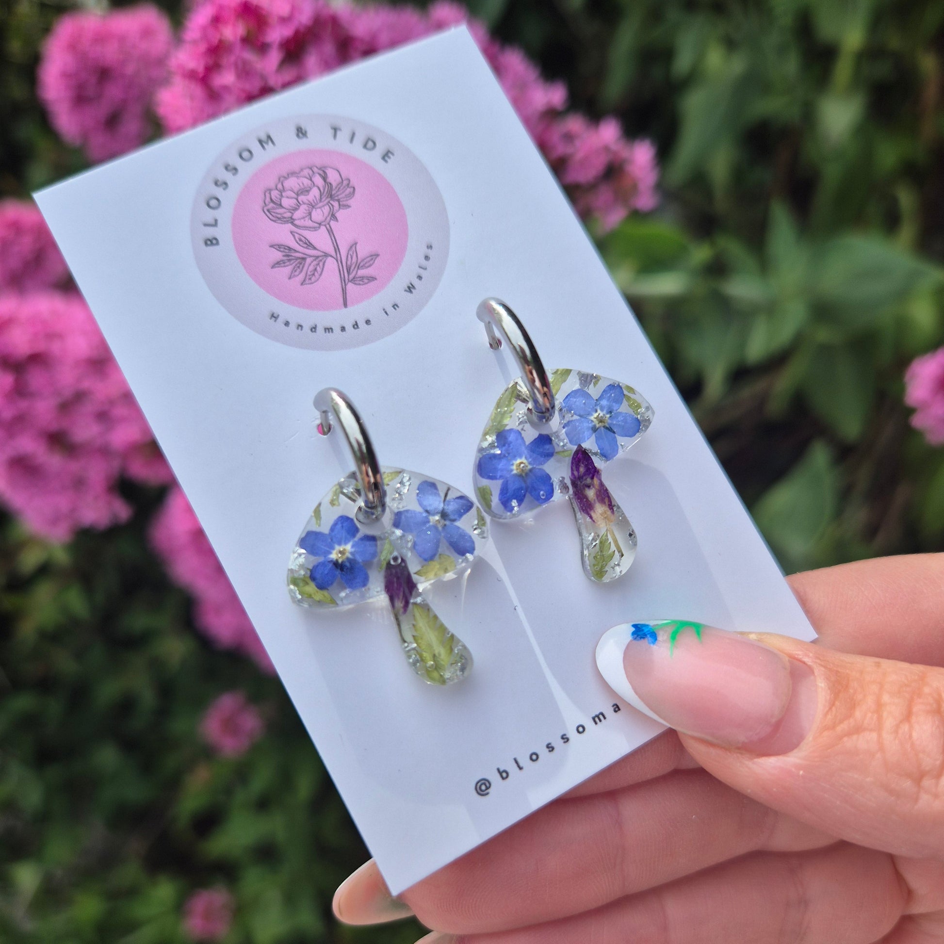 mushroom shaped earrings with real pressed forget-me-nots on silver stainless steel hoops