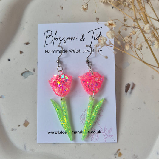 Floral glitter earrings displayed on branded jewellery card.