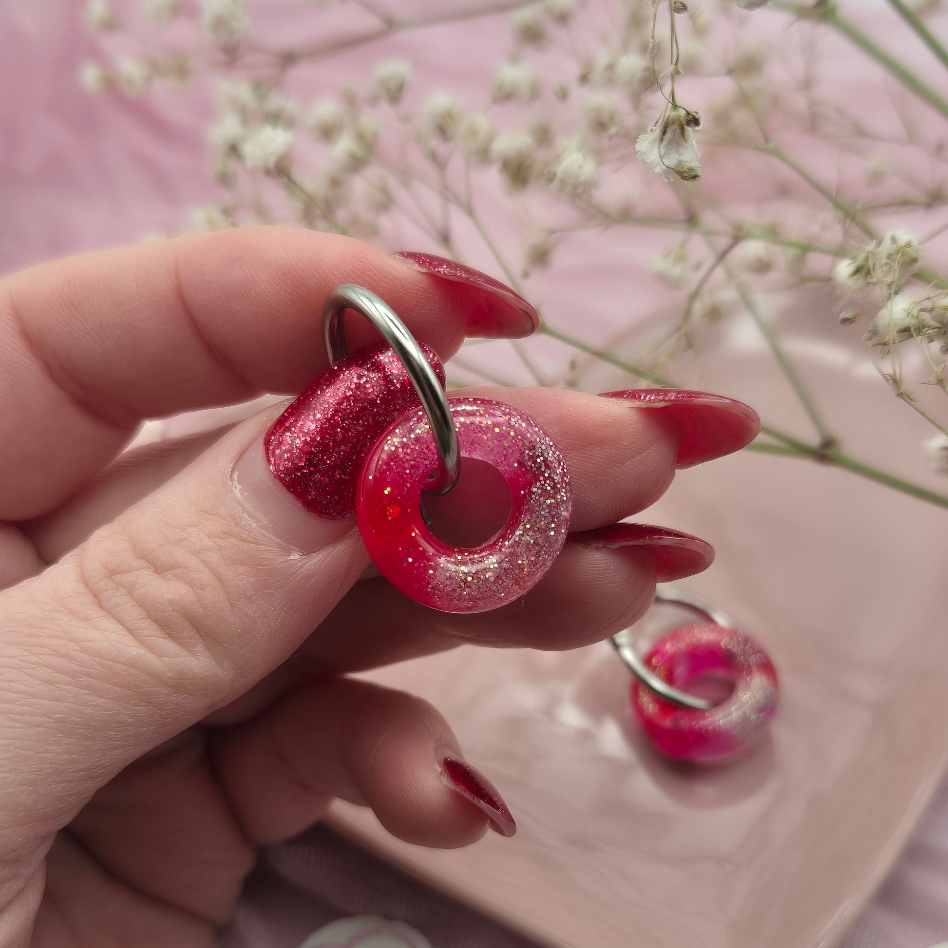 Romantic handcrafted donut hoop earrings presented on a branded card.
