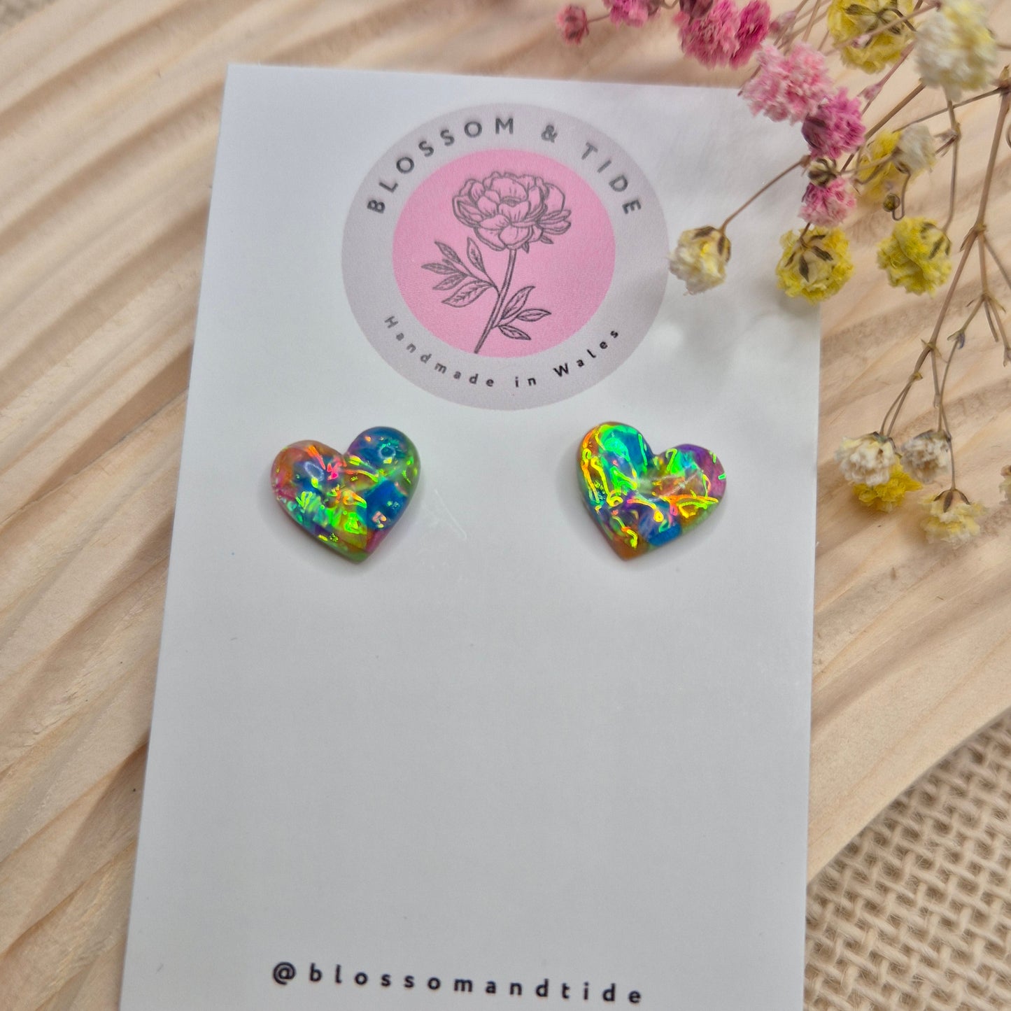 Heart-shaped stud earrings on branded display card, presented in an organza gift bag