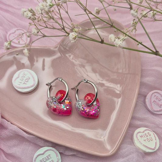 Romantic handcrafted heart hoop earrings presented on a branded card.