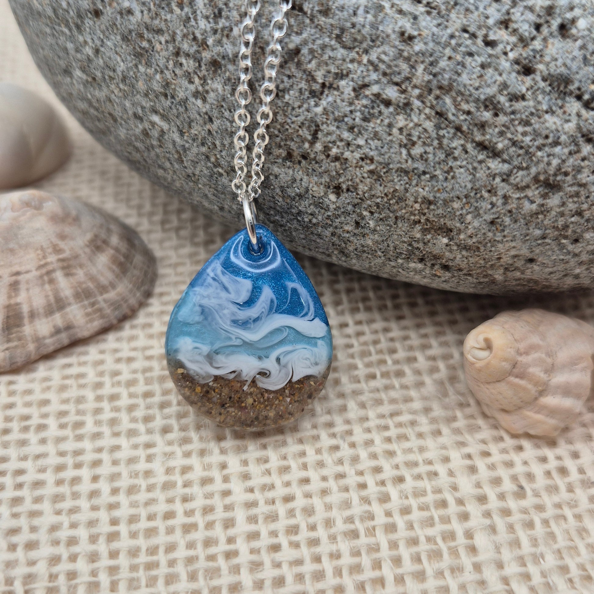 Handmade resin pendant featuring sand from West Wales beaches.