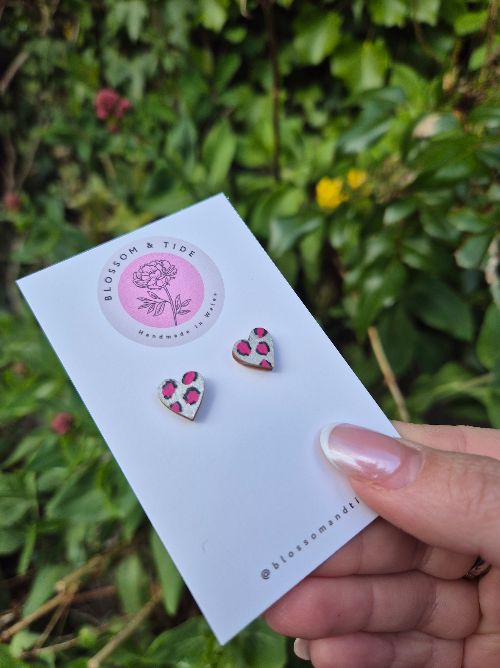 Hand painted metallic animal print heart shaped stud earrings on blossom and tide branded earring card 