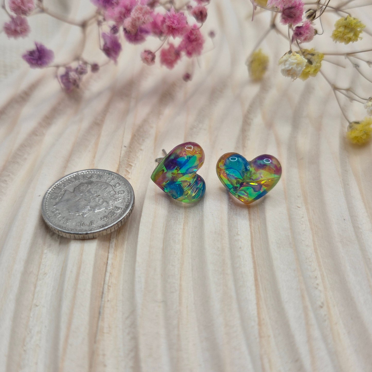 Holographic resin earrings catching the light, ideal for romantic or everyday wear