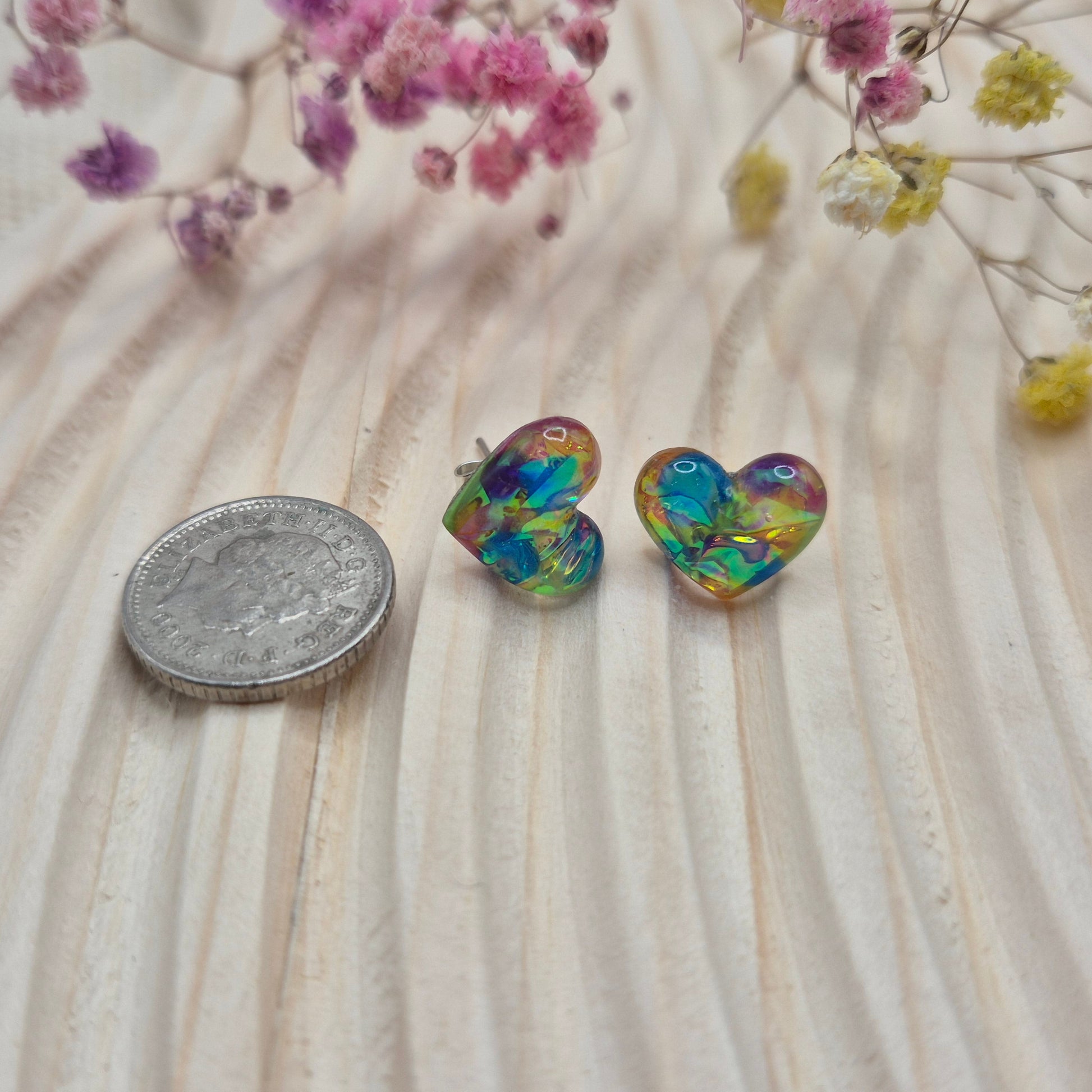 Holographic resin earrings catching the light, ideal for romantic or everyday wear