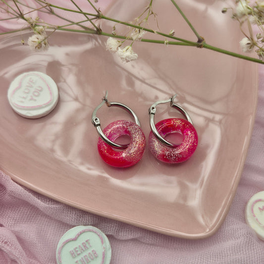 Romantic handcrafted donut hoop earrings presented on a branded card.