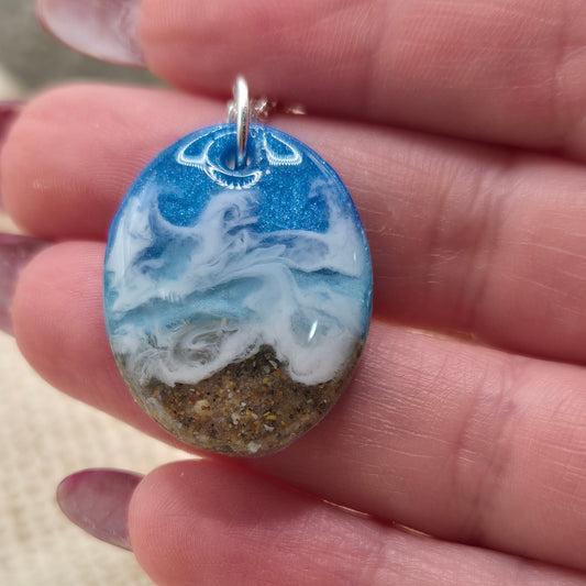 Handmade resin pendant featuring sand from West Wales beaches.