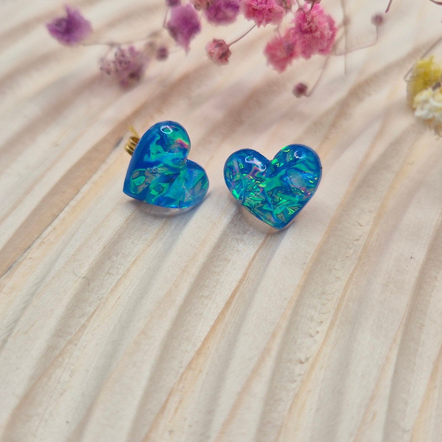 Heart-shaped stud earrings on branded display card, presented in an organza gift bag