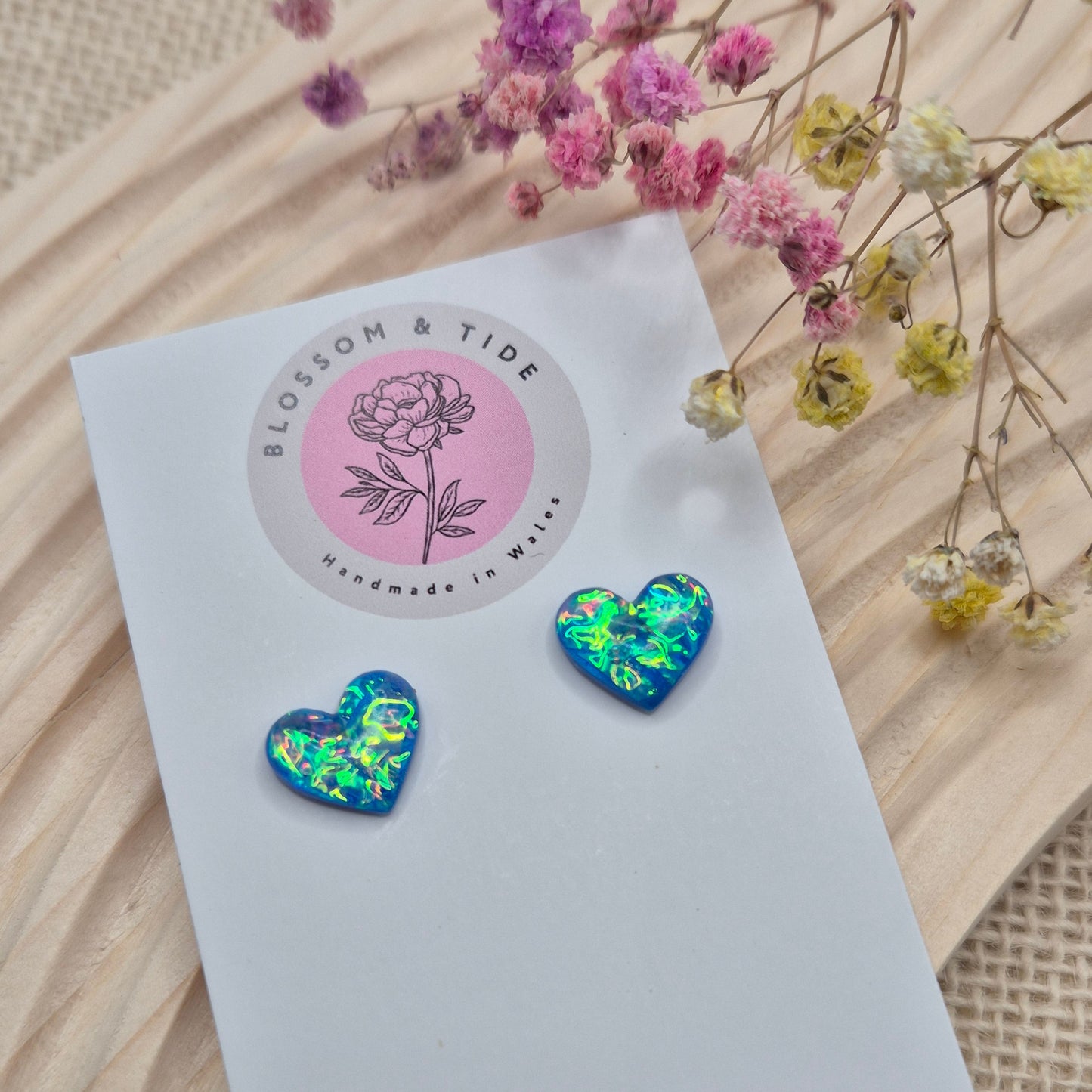 Heart-shaped stud earrings on branded display card, presented in an organza gift bag