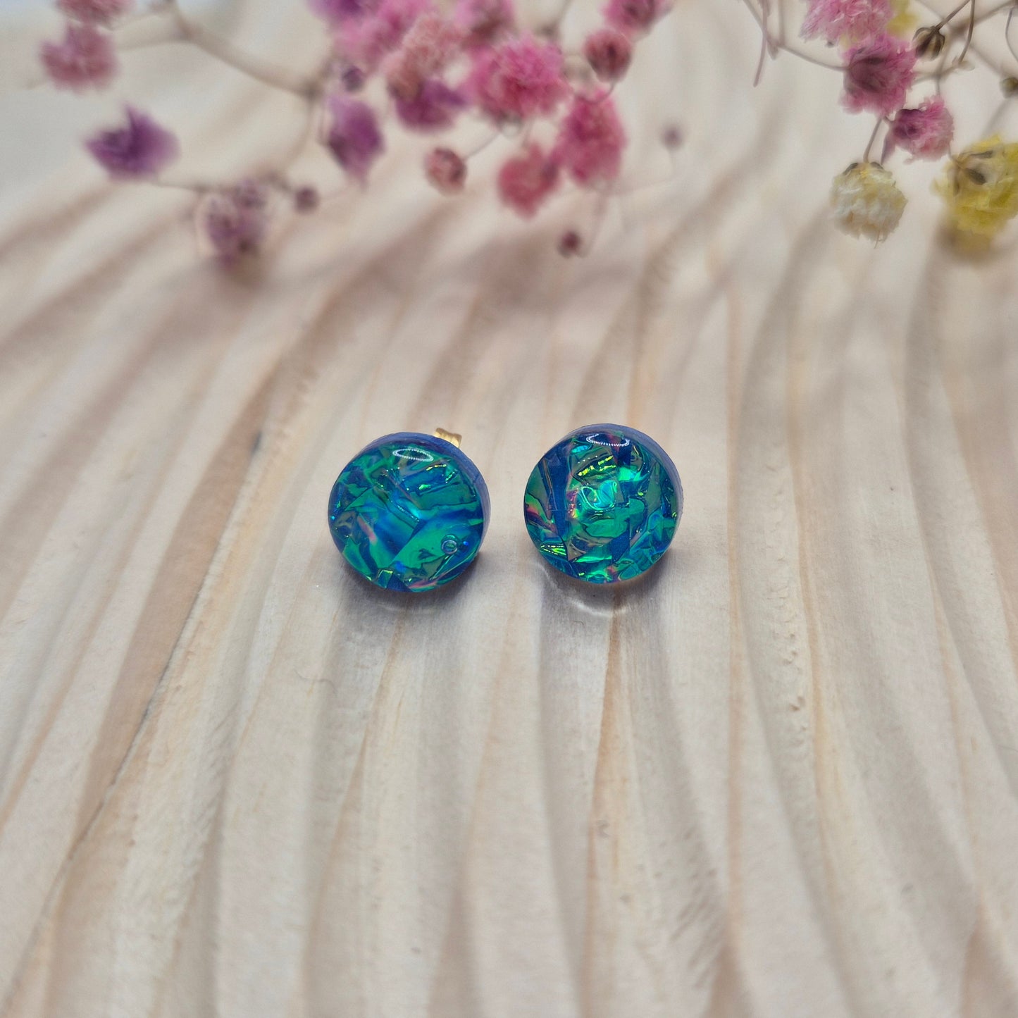 Close-up of iridescent resin earrings, unique handmade jewellery