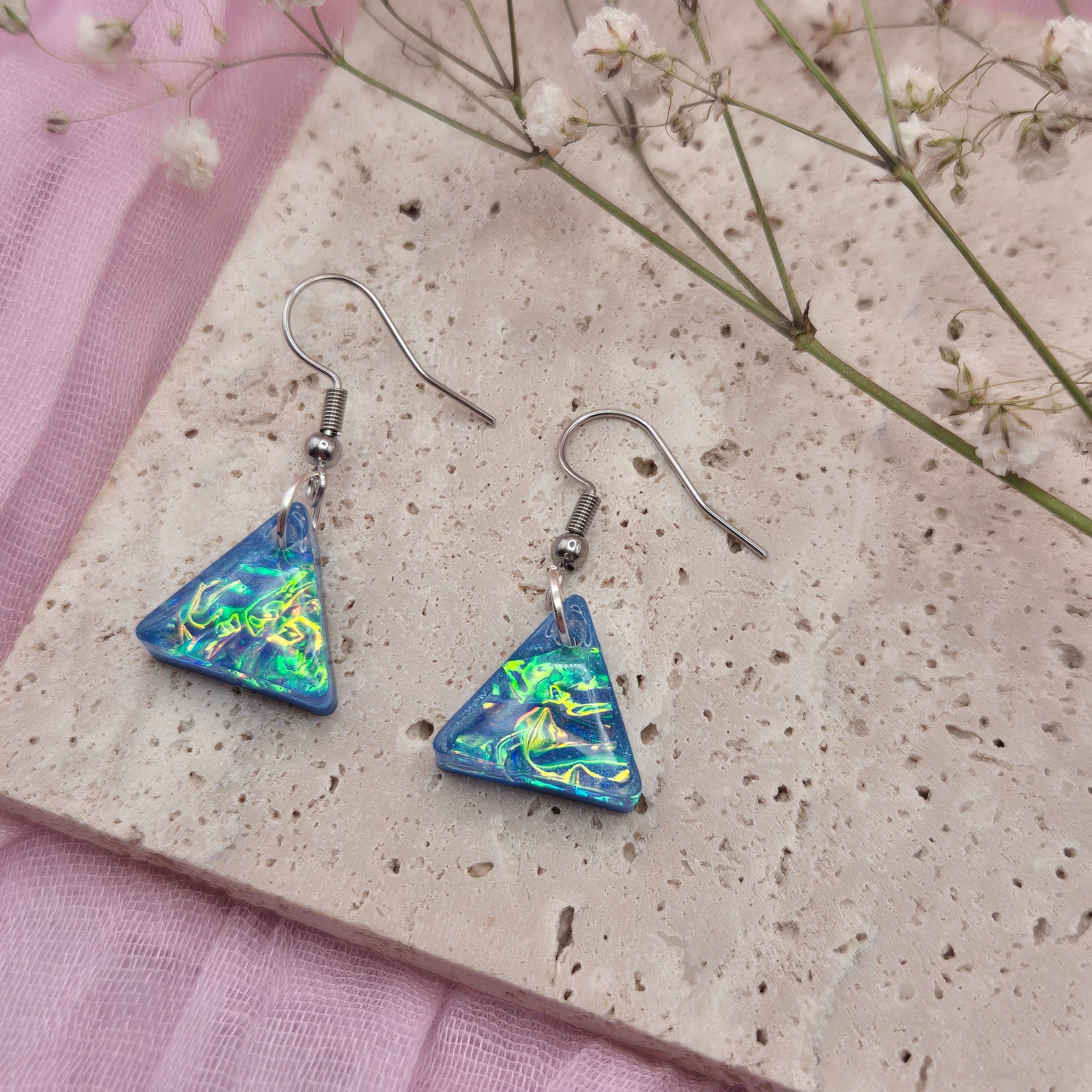 Modern geometric earrings with a shimmering holographic effect, ideal for special occasions or gifting.