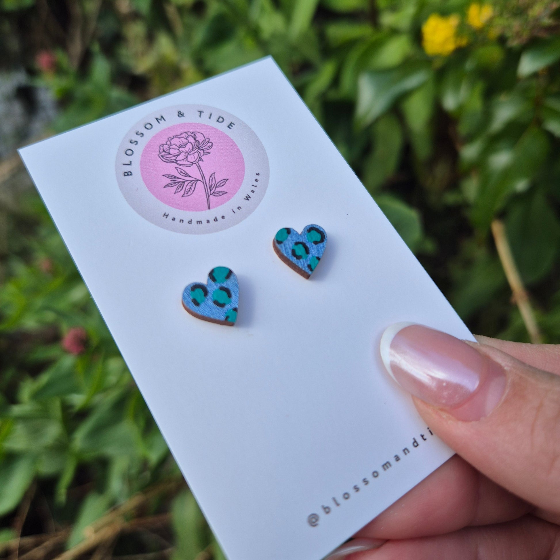 Hand painted metallic animal print heart shaped stud earrings on blossom and tide branded earring card 