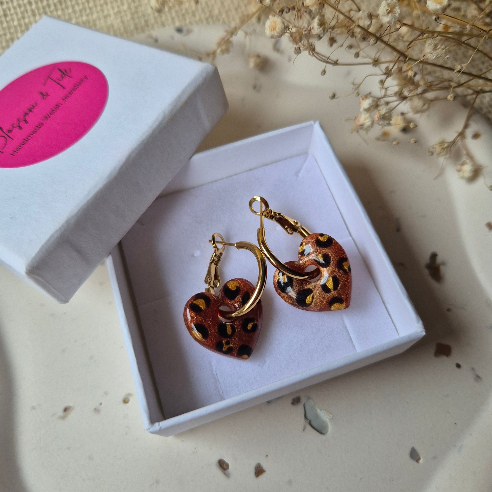 Bronze leopard print earrings in a blossom and tide gift box against a neutral background