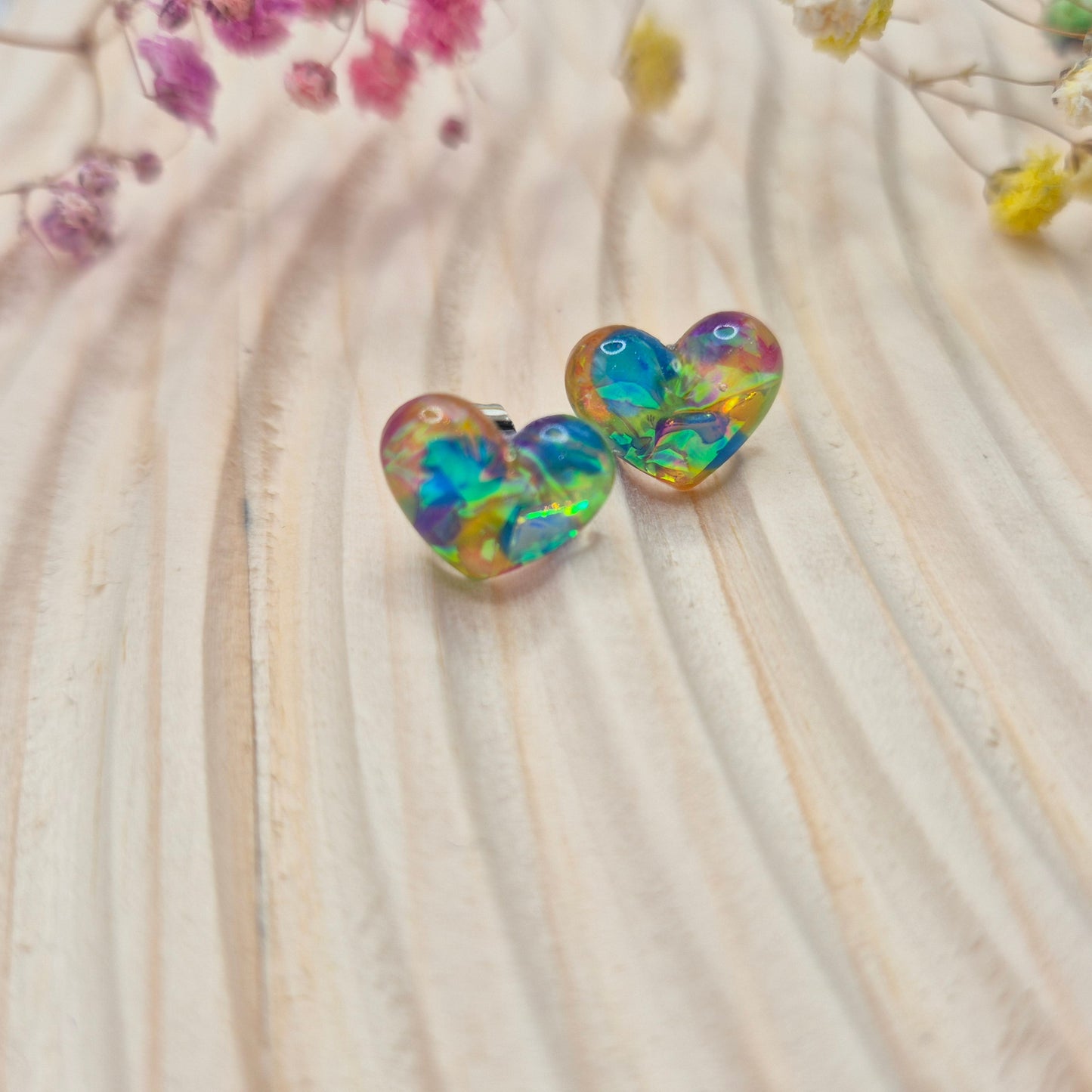 Holographic resin earrings catching the light, ideal for romantic or everyday wear