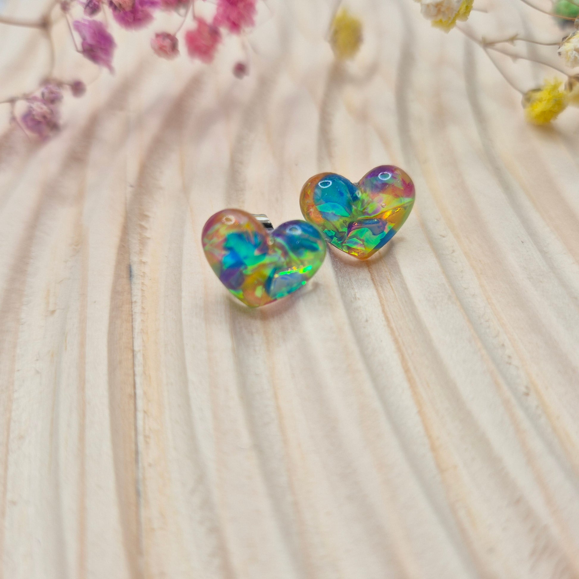 Holographic resin earrings catching the light, ideal for romantic or everyday wear
