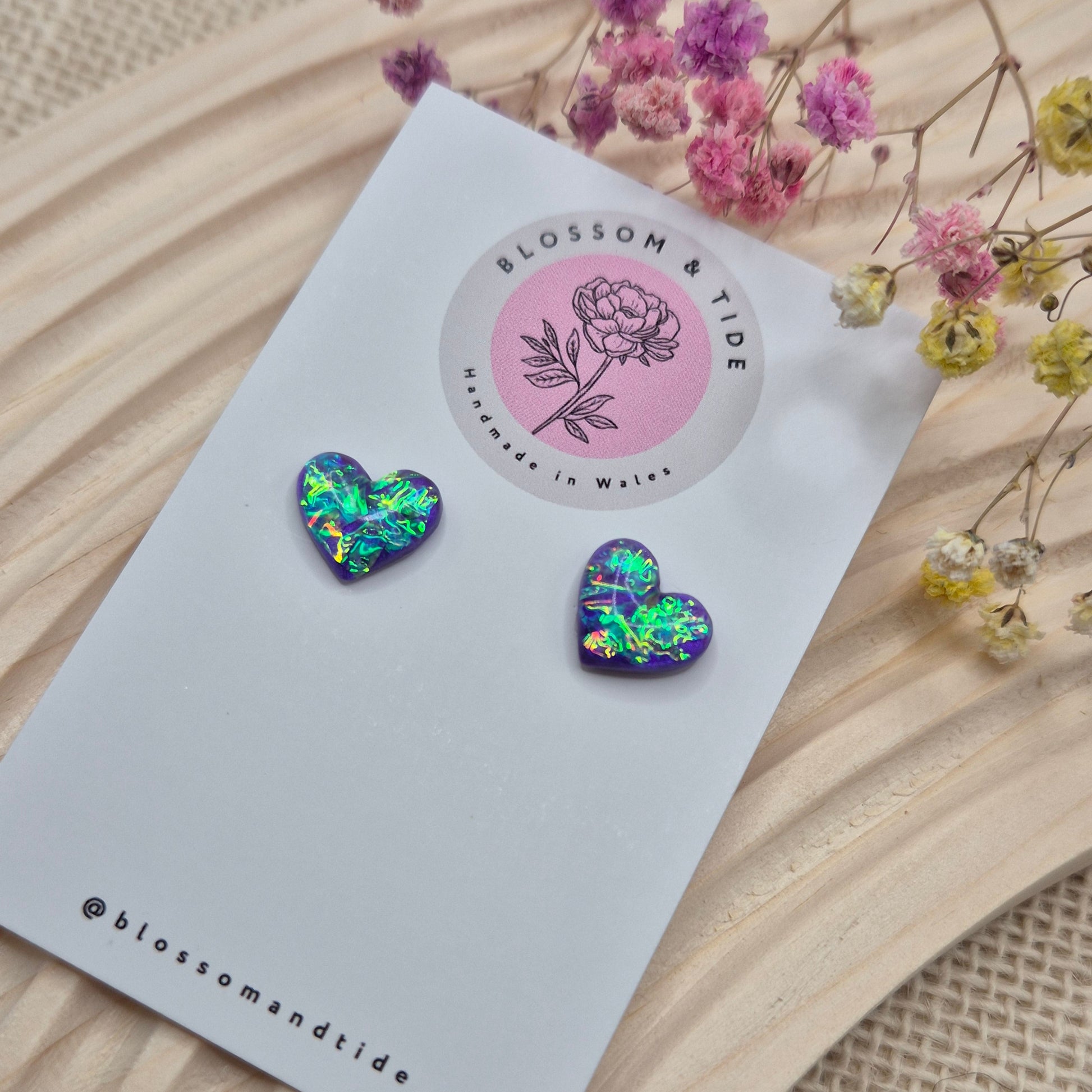 Heart-shaped stud earrings on branded display card, presented in an organza gift bag